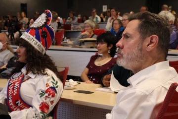 Nadira Sage Mitchell (Diné/Navajo) and Michael Mulcahy listen to the expert panel discussion from the front row during the premiere event.