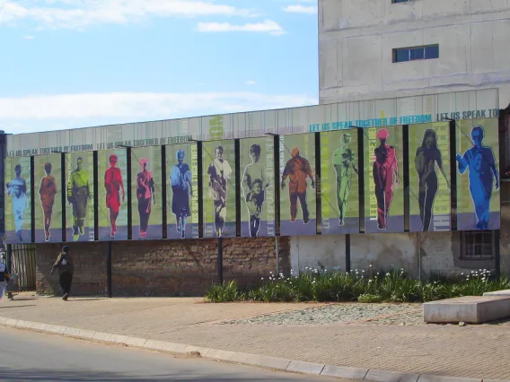 art on building that reads "let us speak together of freedom"