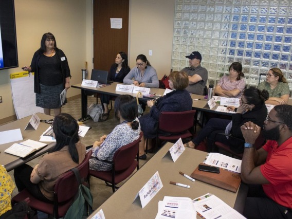Native Know-How instructor Joan Timeche delivers a seminar to a crowded classroom in 2019.