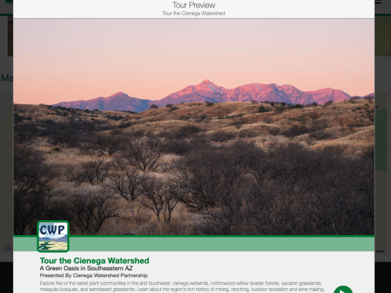 A screenshot of the virtual Tour of the Cienega Watershed shows pink mountains behind high-desert scrub land. A green and white banner at the bottom features the Cienega Watershed Partnership logo and an invitation to "Tour the Cienega Watershed."