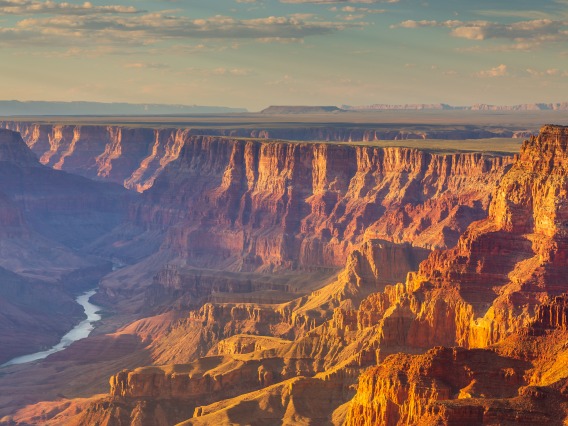 The Colorado River snakes through the red walls of the Grand Canyon