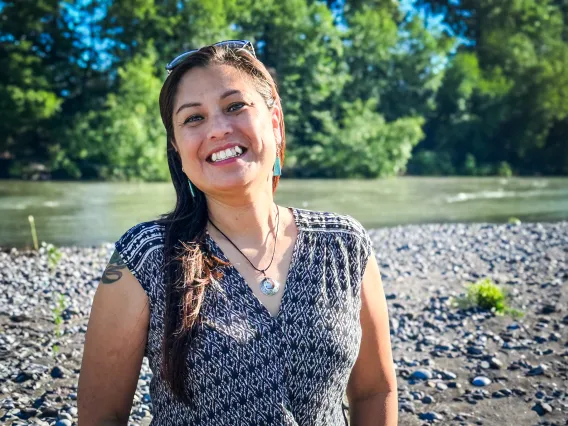 RaeAnna Rabang smiles in front of a river.