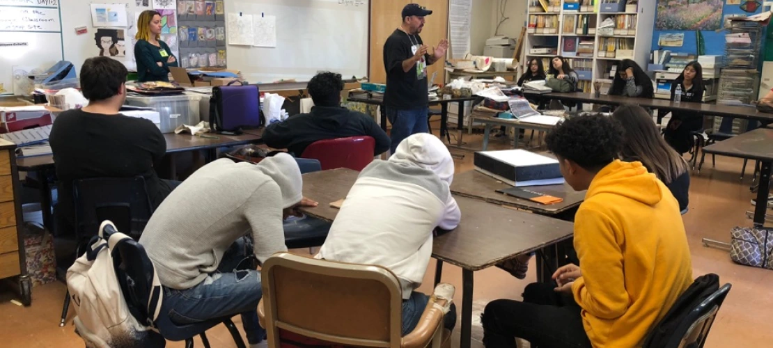 Local artist, Carlos Valenzuela, training high school students in mosaic work.