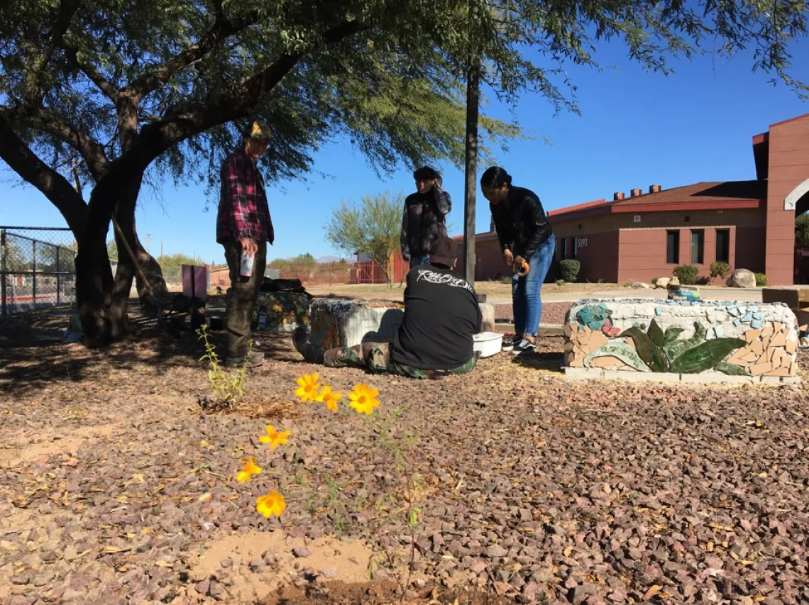 Students working with mosaics on straw bale benches at Star.