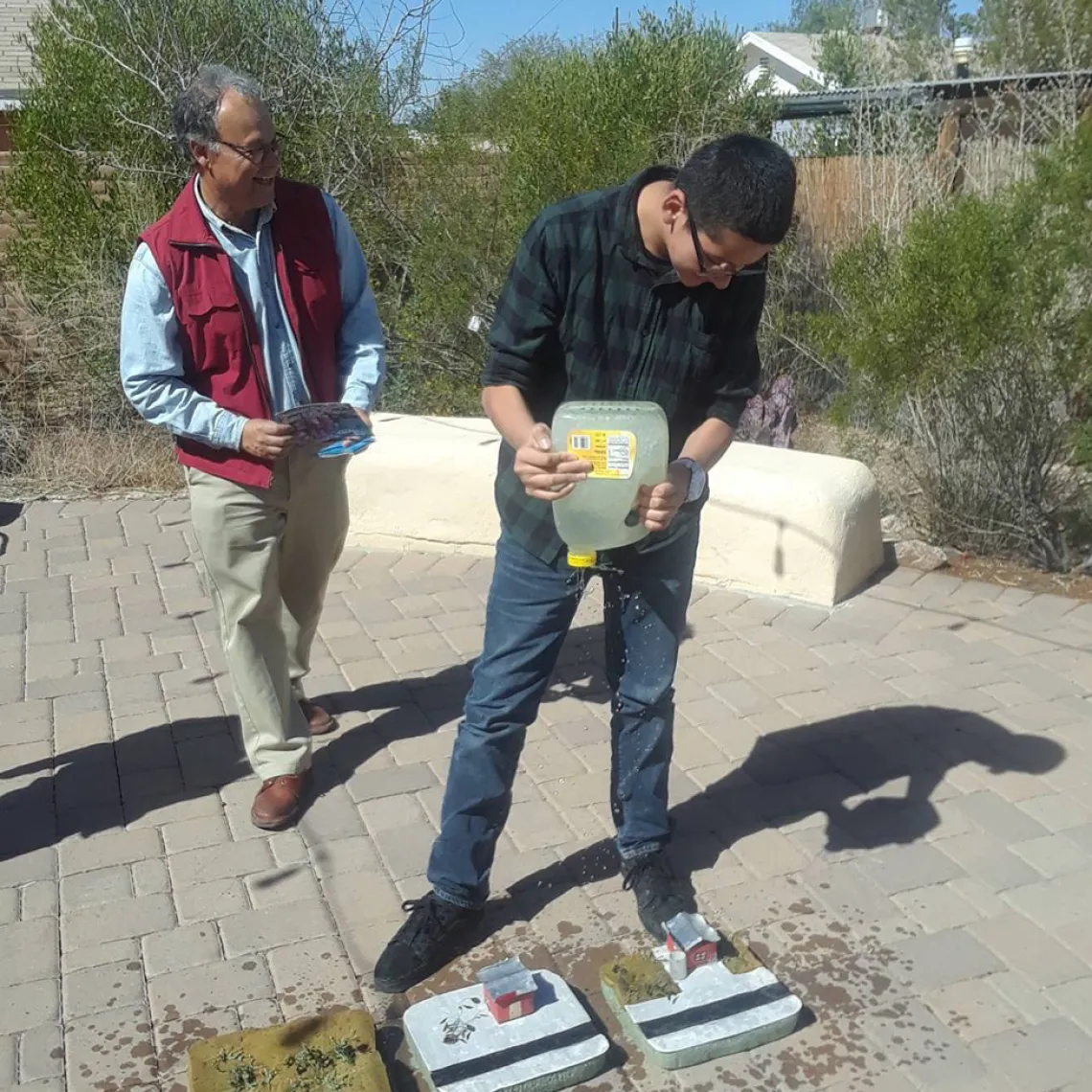 Hollinger middle school students pouring water to the different models at Watershed Management Group facilities