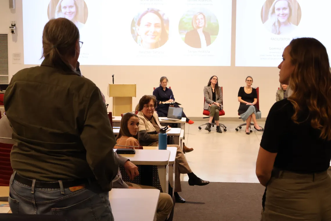 An audience member asks a question to panelists during the symposium.