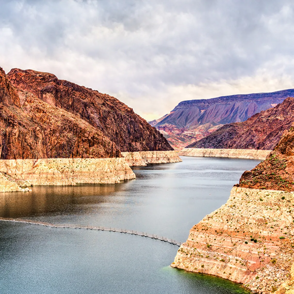 An image of Lake Mead showing a stark white water line where the depth of the lake has receded as a result of prolonged drought.