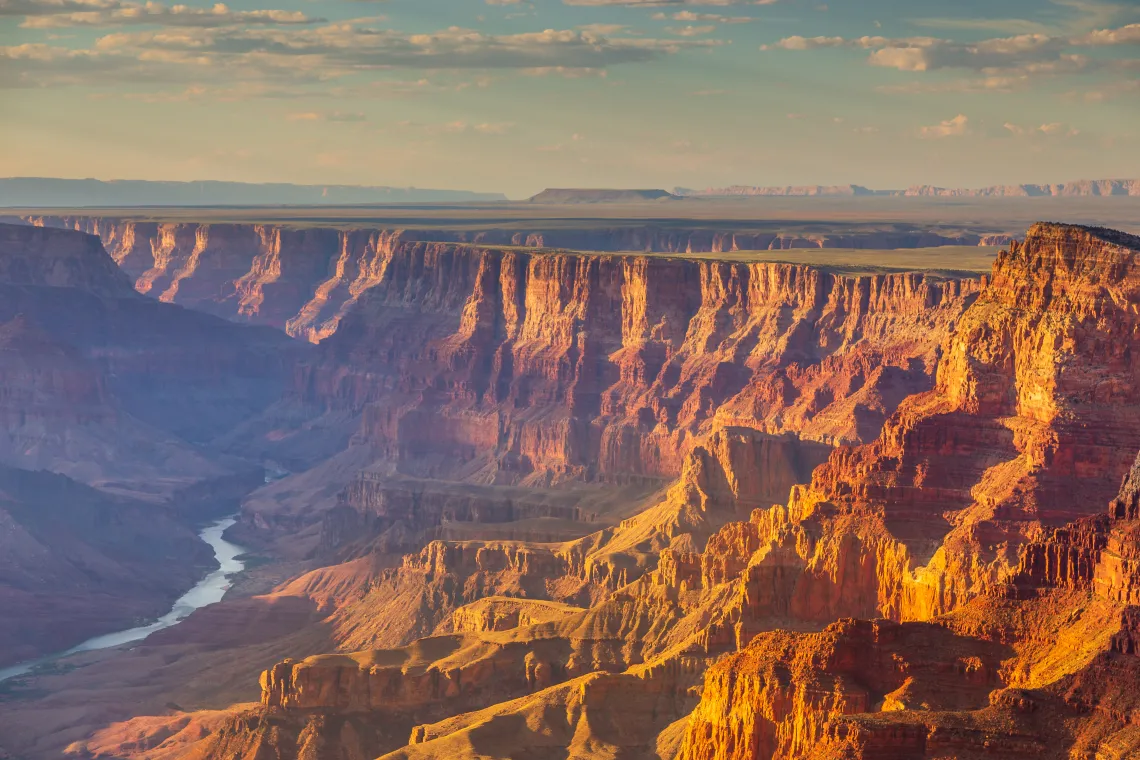 The Colorado River snakes through the red walls of the Grand Canyon