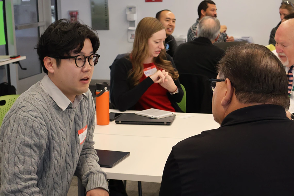 U of A Postdoctoral Researcher Minwoo Ahn chats with an attendee during a breakout session at the 2025 Southern Arizona Heat Summit