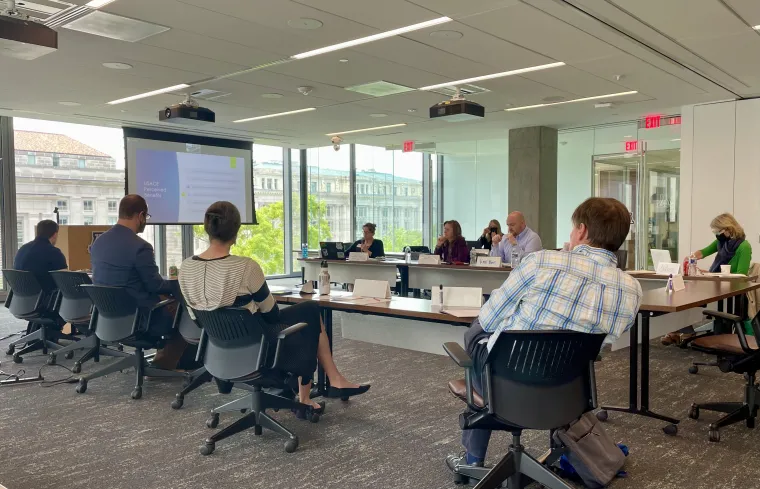 People in a conference room viewing a presentation projected onto a screen