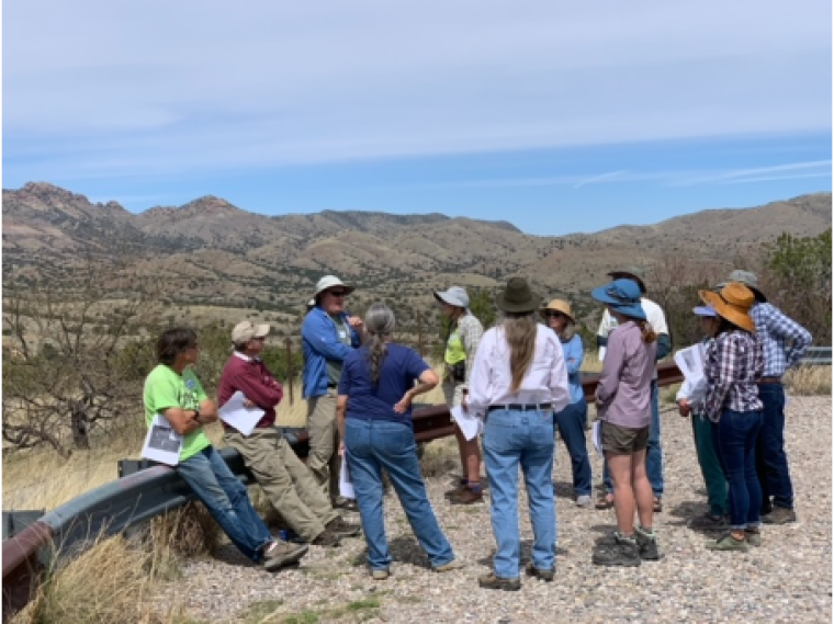 Tom Meixner in a blue shirt and wide-brimmed canvas hat leads a small tour of the Cienega watershed.
