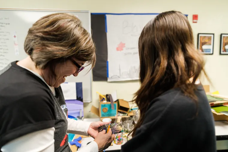 Jackie Nichols coaches a female student on a Future City project. 