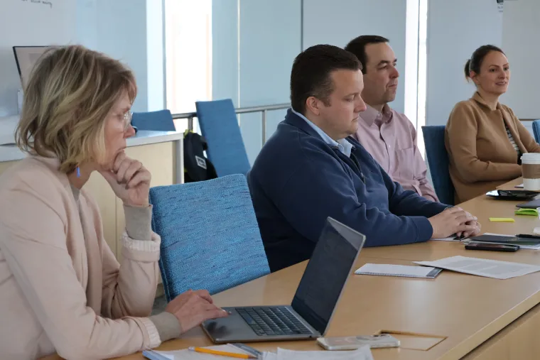 Andrea Gerlak, Rhett Larson, Drew Bennett and Heather Tanana sit at a conference table during the water governance workshop in Tucson.