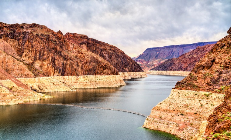 Lake Mead above Hoover Dam with a stark white line to show a depleted water level.