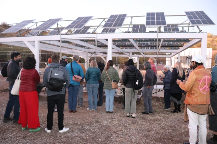 Event attendees examine the agrivoltaic setup at Biosphere2