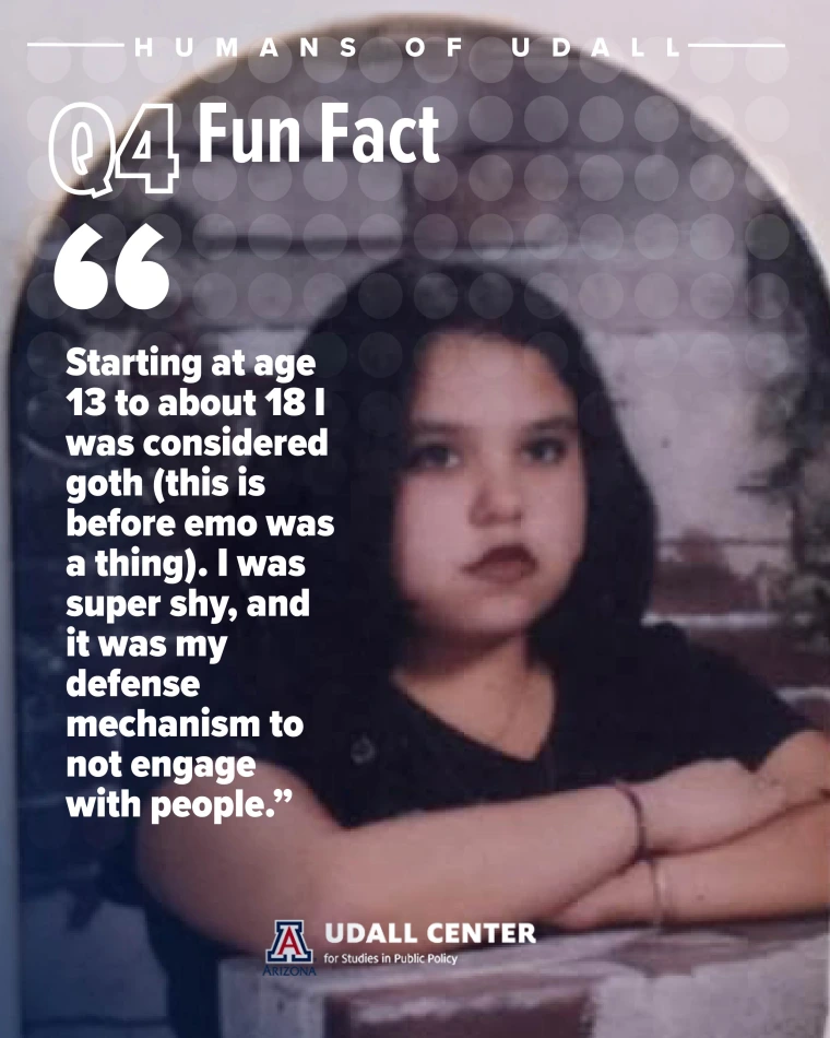 School picture of young Naomi unsmiling in a black t shirt and dark lipstick