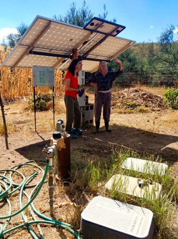 photo of scientists with solar panels in a garden