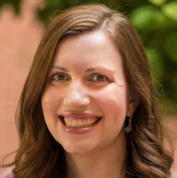 Portrait of Jessica Rainbow smiling outdoors.