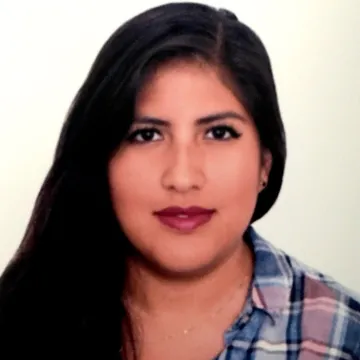 Headshot of Alejandra Jimenez Ortega in a blue and pink plaid shirt against a white background.