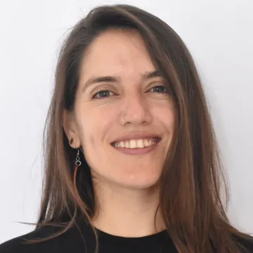 Headshot of Regina Loza Cardenas in a black t-shirt against a white background.