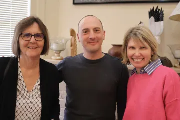 Edella Schlager, Stephan Moyson and Andrea Gerlak pose for a group photo in the Udall Center lobby.