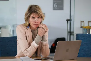 Andrea Gerlak listens intently with her hands folded in front of her during a grant workshop in February 2024.