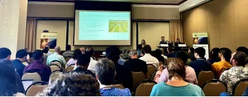 Neesham-McTiernan, Lepley and one unnamed researcher presents to a full room at AWC 2024.