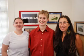 Cara Buchanan poses between mentors Jewel Cummins and Stephanie Russo Carroll in Dr. Carroll's Udall Center office.