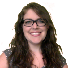 Molli Bryson in glasses and a dark blue polka dot sleeveless shirt against a white background