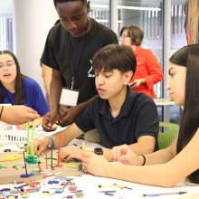 Middle school students work to build an ocotillo out of colorful Kinex toys during a visit to UArizona in September 2023.