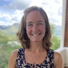 Alison Elder poses for a photo in front of a window on a sunny day