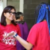 Adriana listens as a middle school student speaks to her about a project in 2024