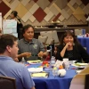 Four Native leaders chat around a round table during group work at the 2025 Emerging Leaders Seminar