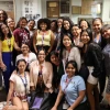 SUSI students pose with program manager Marcela Vasquez-Leon and NNI staff in front of a trophy case belonging to the U of A School of Journalism