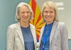 Andrea Gerlak poses with fellow Tucson Water Citizen's Water Advisory Committee member Juliet McKenna in doors in front of an Arizona flag.