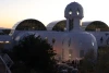 Biosphere 2 at sunset. String lights can be seen at the base of the building.